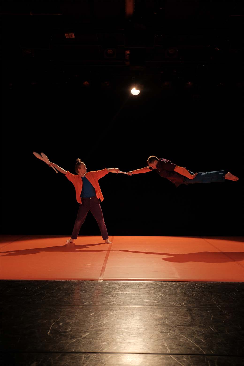 Photo de deux personnes réalisant une figure acrobatique